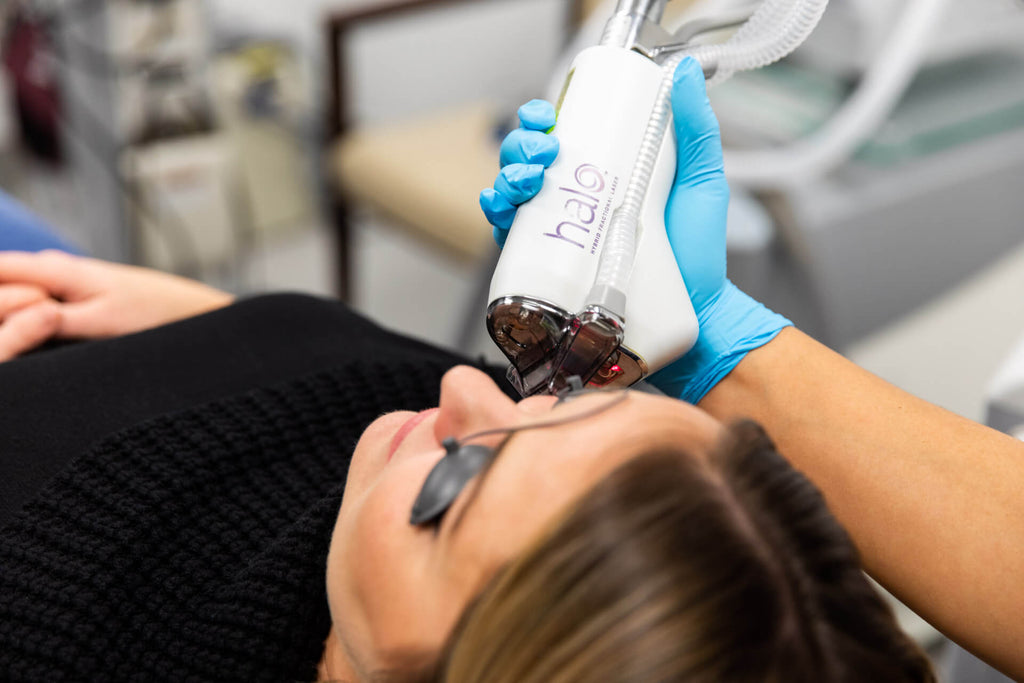 Woman laying down for a HALO laser treatment procedure by the dermatologist